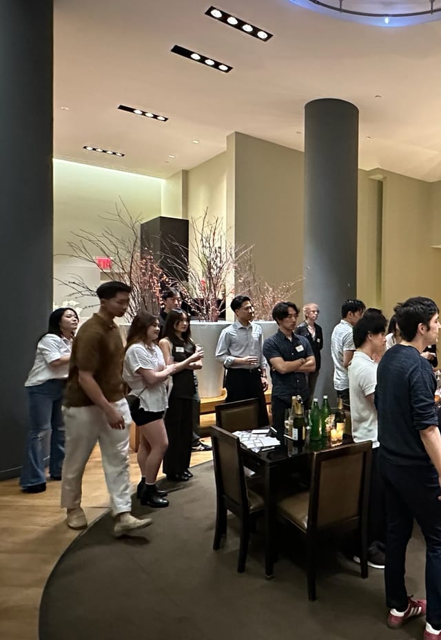 Guests standing and talking at a Once event in New York